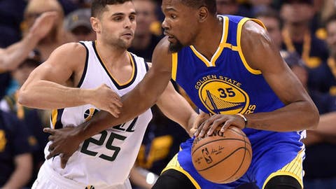 SALT LAKE CITY UT- MAY 6 Raul Neto #25 of the Utah Jazz defends against Kevin Durant #35 of the Golden State Warriors in the first half in Game Three of the Western Conference Semifinals during the 2017 NBA Playoffs at Vivint Smart Home Arena on May 6