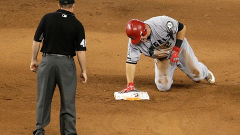 Los Angeles Angels' Mike Trout grimaces after stealing second during the fifth inning of an interleague baseball game against the Miami Marlins Sunday