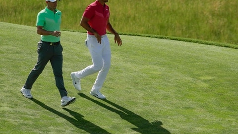 Rory Mcilroy of Ireland and Jason Day of Australia walk on the eighth hole during the first round of the U.S. Open golf tournament Thursday
