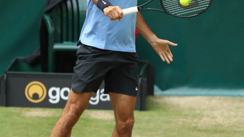 Switzerland's Roger Federer hits a backhand to beat Germany's Florian Mayer in the quarterfinal of the ATP tournament in Halle Germany Friday