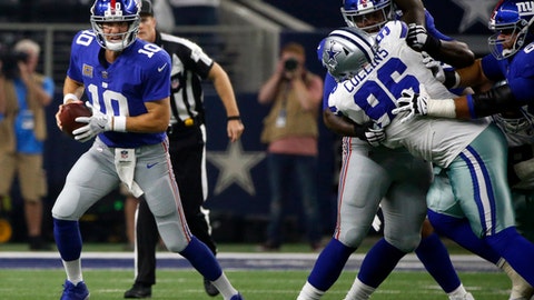 New York Giants quarterback Eli Manning scrambles out of the pocket under pressure from Dallas Cowboys defensive tackle Maliek Collins in the first half of an NFL football game Sunday Sept. 10 2017 in Arlington Texas. (AP