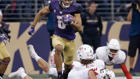 Washington's Dante Pettis leaves several Fresno State defenders in his wake on his punt return for a touchdown in the first half of an NCAA college football game Saturday Sept. 16 2017 in Seattle. Pettis tied the NCAA career record for punt
