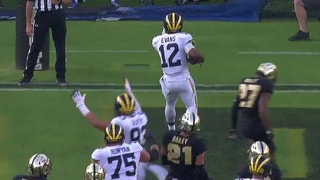 Michigan's Chris Evans scores on a 10-yd touchdown run