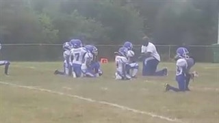 8-and-under youth football team takes knee during the national anthem