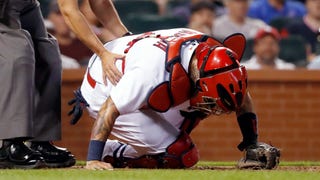 WATCH: Yadi leaves game after taking back-to-back foul balls off the mask