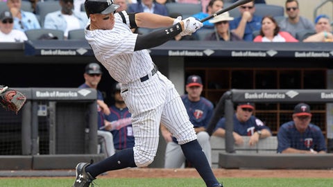New York Yankees' Aaron Judge hits a two-run home run during the third inning of a baseball game against the Minnesota Twins in New York. Houston dynamo Jose Altuve and Yankees slugger Aaron Judge are the