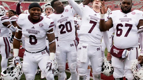 Mississippi State players Kylin Hill Taury Dixon Nick Fitzgerald and Michael Story celebrate their win over Arkansas during an NCAA college football game Saturday Nov. 18 2017 in Fayetteville Ark