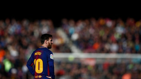 FC Barcelona's Lionel Messi looks on during a Spanish La Liga soccer match between FC Barcelona and Celta Vigo at the Camp Nou stadium in Barcelona Saturday Dec. 2 2017