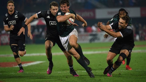 South Africa's Kwagga Smith front slips through New Zealand's defence in the final of the World Rugby Sevens Series in Dubai the United Arab Emirates Saturday Dec. 2 2017. South Africa beat New Zealand 24-12 defending its last year's