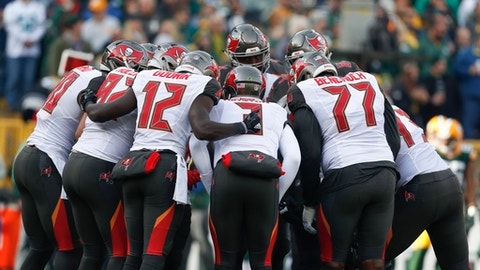 Tampa Bay Buccaneers quarterback Jameis Winston leads a huddle during the first half of an NFL football game against the Green Bay Packers Sunday Dec. 3 2017 in Green Bay Wis