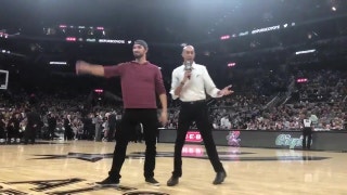 Texas Rangers pitcher Tony Barnette helps toss t-shirts at Spurs game