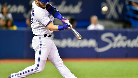 Toronto Blue Jays' Josh Donaldson hits a three-run home run against the Tampa Bay Rays during the fifth inning of a baseball game in Toronto. The hot corner figures to be smoking Friday Jan. 12 2018 when