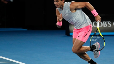 Spain's Rafael Nadal dashes to reach the ball as he plays Victor Estrella Burgos of the Dominican Republic during their first round match at the Australian Open tennis championships in Melbourne Australia Monday Jan. 15 2018. (AP