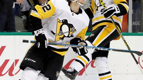 Pittsburgh Penguins left wing Carl Hagelin, of Sweden and Jamie Oleksiak celebrate a goal scored by Hagelin during the first period of an NHL hockey game against the Dallas Stars on Friday Feb. 9 2018 in Dallas