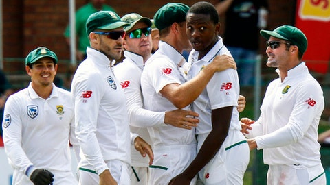 South Africa's bowler Kagiso Rabada second right with teammate celebrates after dismissing Australia's batsman Shaun Marsh for 24 runs on the first day of the second cricket test match between South Africa and Australia at St George's Pa