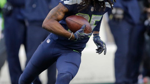Seattle Seahawks cornerback Richard Sherman runs after he intercepted a pass rom Houston Texans quarterback Deshaun Watson late in the second half of an NFL football game in Seattle. The Seahawks