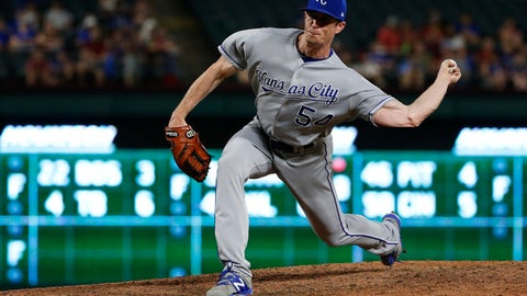 Kansas City Royals relief pitcher Tim Hill delivers to a Texas Rangers batter during the eighth inning of a baseball game Thursday