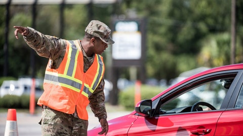 A National Guardsman directs traffic onto U.S. Highway 501 as Hurricane Florence approaches the East Coast Wednesday Sept. 12 2018 near Conway S.C. Time is running short to get out of the way of Hurricane Florence a monster of a storm