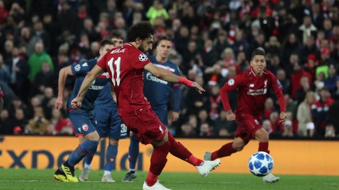Liverpool forward Mohamed Salah shoots and scores his sides 3rd goal from the penalty spot during the Champions League group C soccer match between Liverpool and Red Star at Anfield stadium in Liverpool England Wednesday Oct. 24,2018.(AP