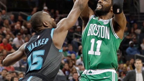 Boston Celtics' Kyrie Irving shoots over Charlotte Hornets' Kemba Walker during the first half of an NBA basketball game in Charlotte N.C. Monday Nov. 19 2018
