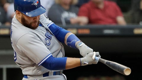 Toronto Blue Jays' Russell Martin hits a solo home run against the Chicago White Sox during the third inning of a baseball game in Chicago. The Los Angeles Dodgers have reacquired catcher Marti