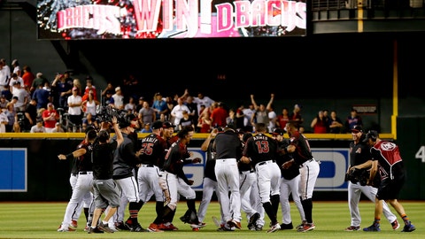 The Arizona Diamondbacks celebrate after defeating the Boston Red Sox in a baseball game Saturday