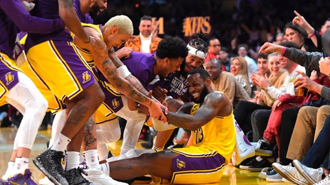 Los Angeles Lakers forward Le Bron James I swarmed by teammates after making several 3-point shots in a row during the second half of the team's NBA basketball game against the San Antonio Spurs on Tuesday Feb. 4 2020 in Los Angeles