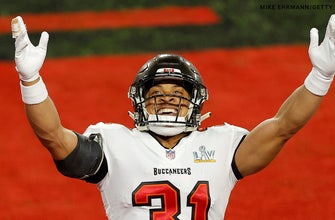 Tampa Bay Buccaneer Antoine Winfield Jr. sports the WWE Title during Super Bowl boat parade
