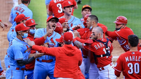 St. Louis Cardinals' Nolan Arenado, center left, reacts alongside teammate catcher Yadier Molina, center, as they scrum with members of the Cincinnati Reds during the fourth inning of a baseball game in Cincinnati, Saturday, April 3, 2021. (AP Photo/Aaron Doster)