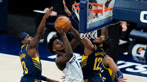 Minnesota Timberwolves' Anthony Edwards (1) puts up a shot against Indiana Pacers' Aaron Holiday and Oshae Brissett (12) during the first half of an NBA basketball game, Wednesday, April 7, 2021, in Indianapolis. (AP Photo/Darron Cummings)