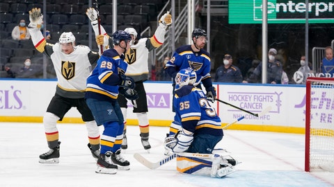 Vegas Golden Knights' Tomas Nosek, left, celebrates after scoring past St. Louis Blues goaltender Ville Husso (35) and Vince Dunn (29) during the first period of an NHL hockey game Monday, April 5, 2021, in St. Louis. (AP Photo/Jeff Roberson)