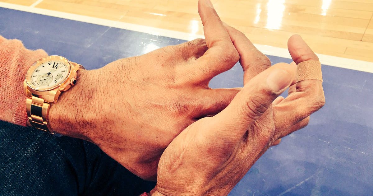 Michael Strahan's fingers are forever bent and mangled 