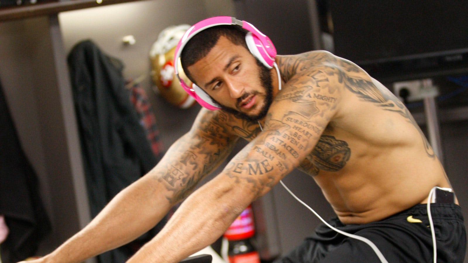 Colin Kaepernick wearing pink Beats headphones