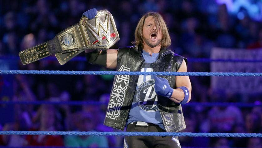 WWE wrestler The Miz shines the belt and temporarily blinds the